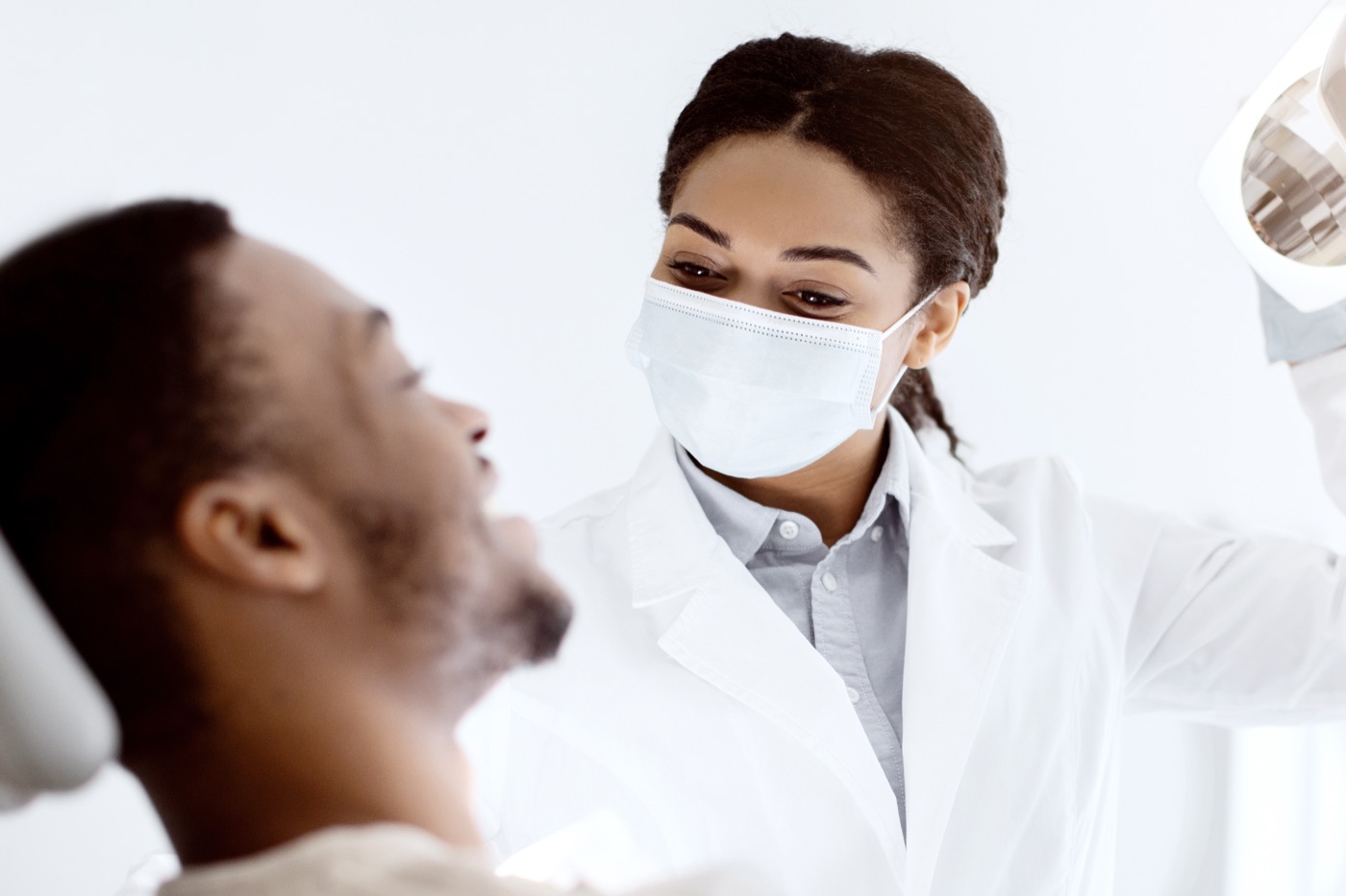 Riverside cosmetic dentist examining a patient during a cosmetic dentistry consultation